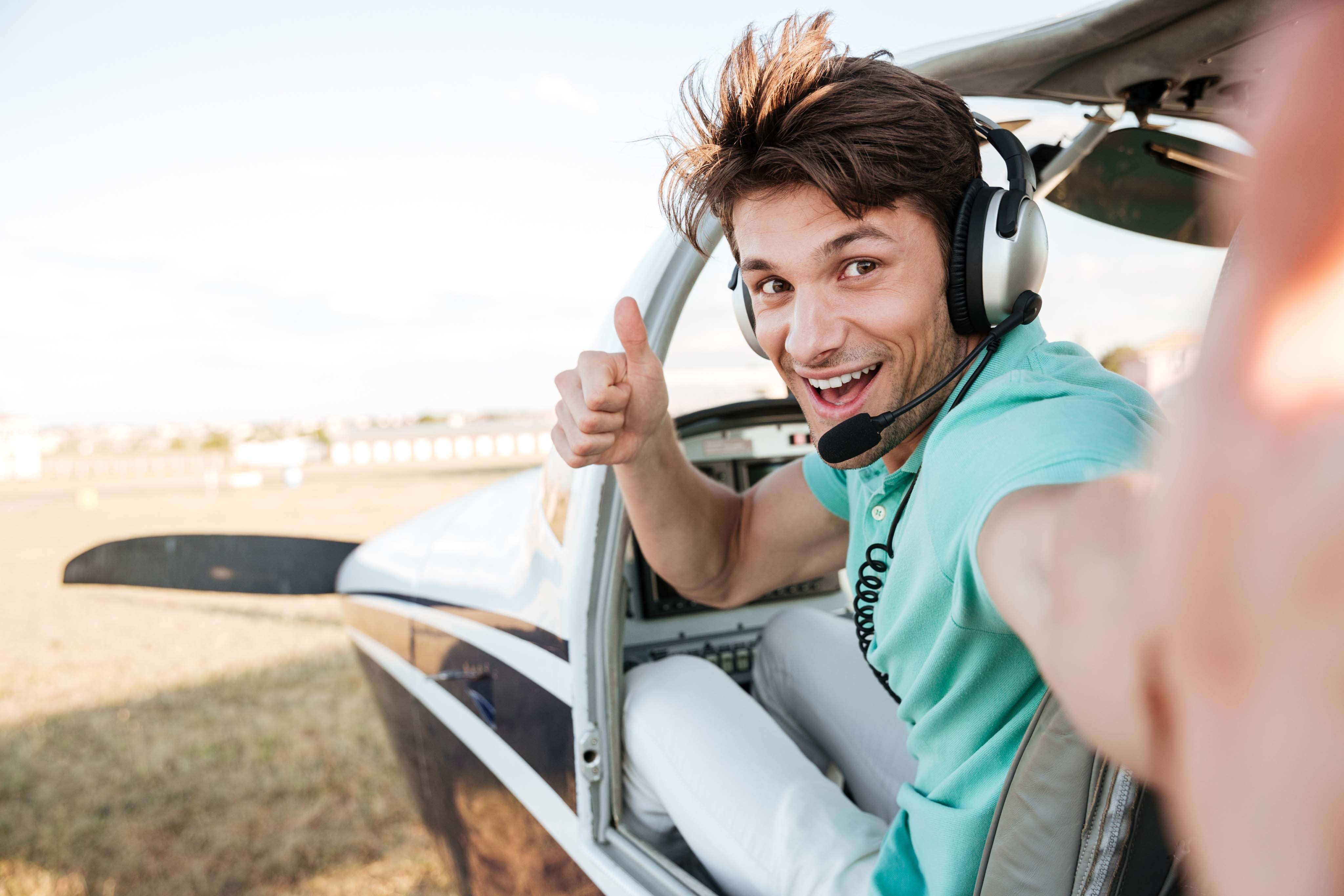 Student pilot smiling from cockpit